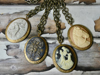 Oval brass locket necklace assorted embellished vintage cameos