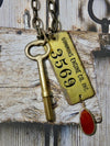 Vintage brass tag and key necklace Cummins Engine Tag #3569 and wind up key
