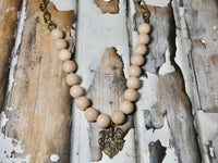 Large beads with bronze charm necklace