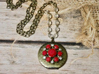 Brass round locket necklace embellished with red vintage earring