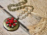 Brass round locket necklace embellished with red vintage earring